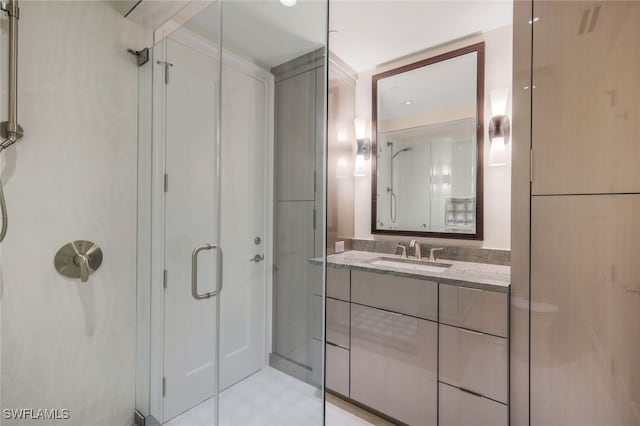 bathroom with a shower with door and vanity