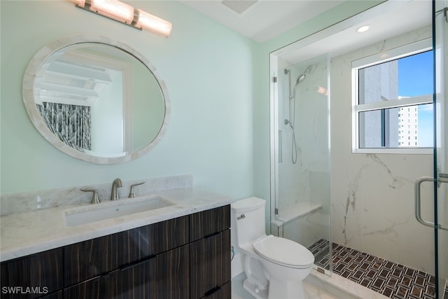 bathroom with walk in shower, vanity, and toilet