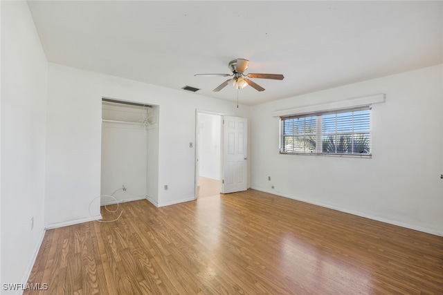 unfurnished bedroom with ceiling fan, light hardwood / wood-style floors, and a closet