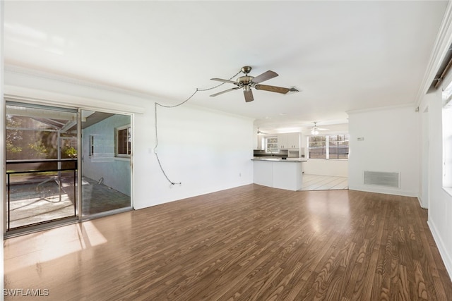 unfurnished living room with ceiling fan, hardwood / wood-style floors, and ornamental molding