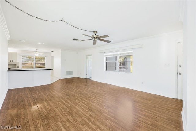 unfurnished living room with light hardwood / wood-style flooring, ceiling fan, and crown molding