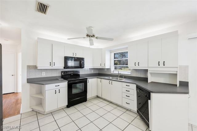 kitchen featuring light tile patterned floors, sink, white cabinetry, and black appliances