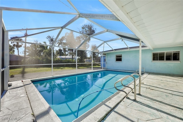 view of swimming pool with a patio area and a lanai