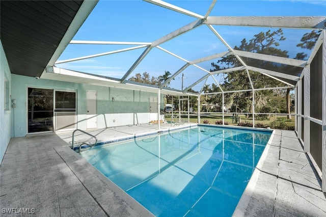 view of pool with a lanai and a patio