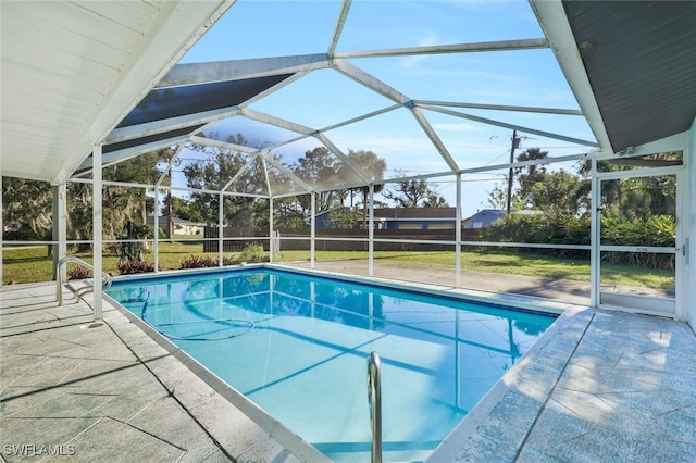 view of pool featuring a lanai, a patio area, and a yard