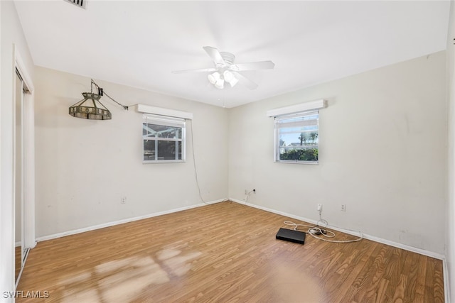 empty room featuring ceiling fan and hardwood / wood-style floors