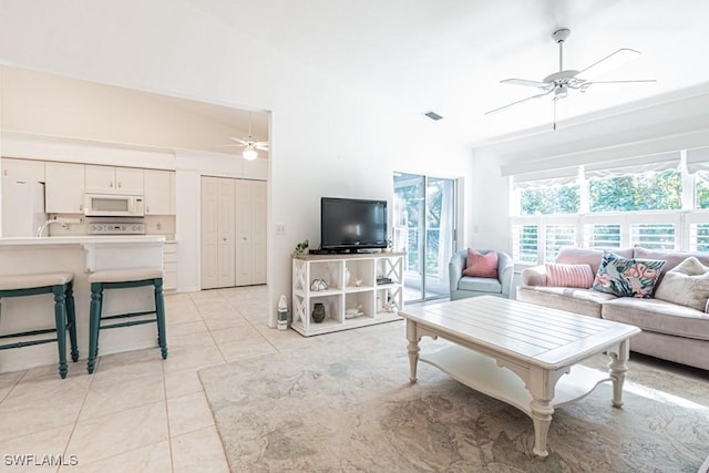 living room featuring lofted ceiling and light tile patterned floors