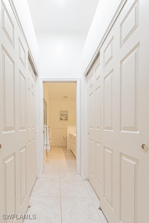 corridor featuring light tile patterned floors