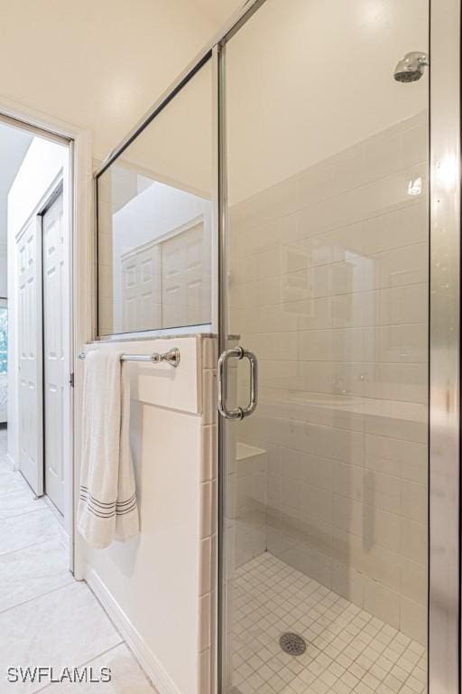 bathroom with tile patterned flooring and walk in shower