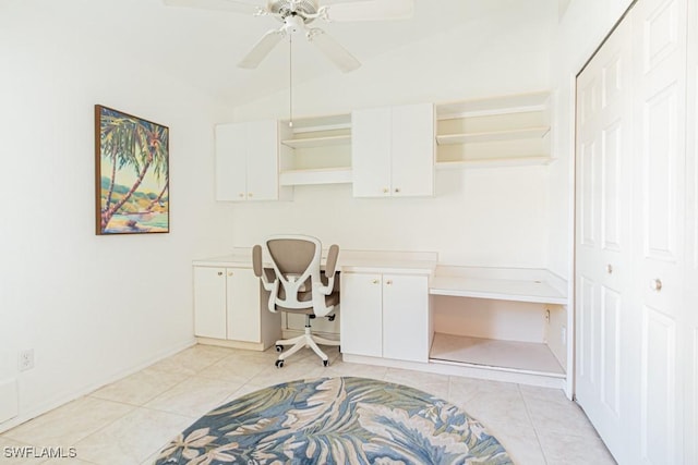 home office featuring built in desk, ceiling fan, and light tile patterned floors