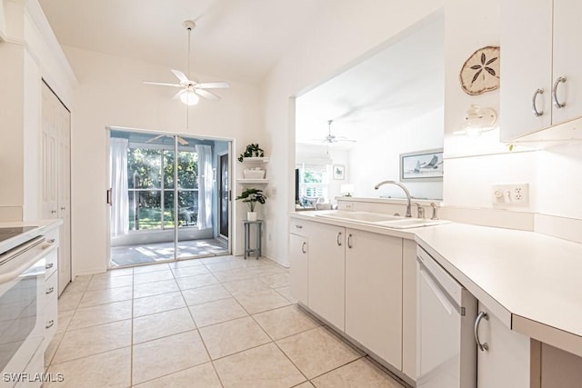 kitchen with dishwasher, sink, white cabinetry, stove, and lofted ceiling