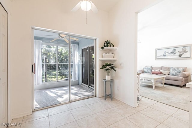 doorway to outside featuring ceiling fan and light tile patterned floors