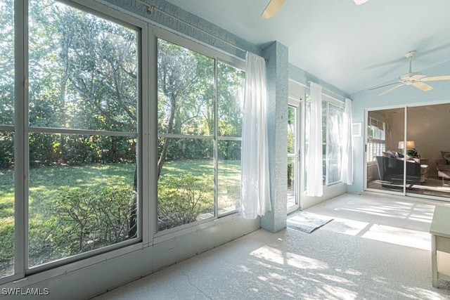 sunroom / solarium with ceiling fan and lofted ceiling