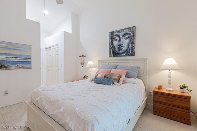 bedroom with ceiling fan, a closet, and high vaulted ceiling