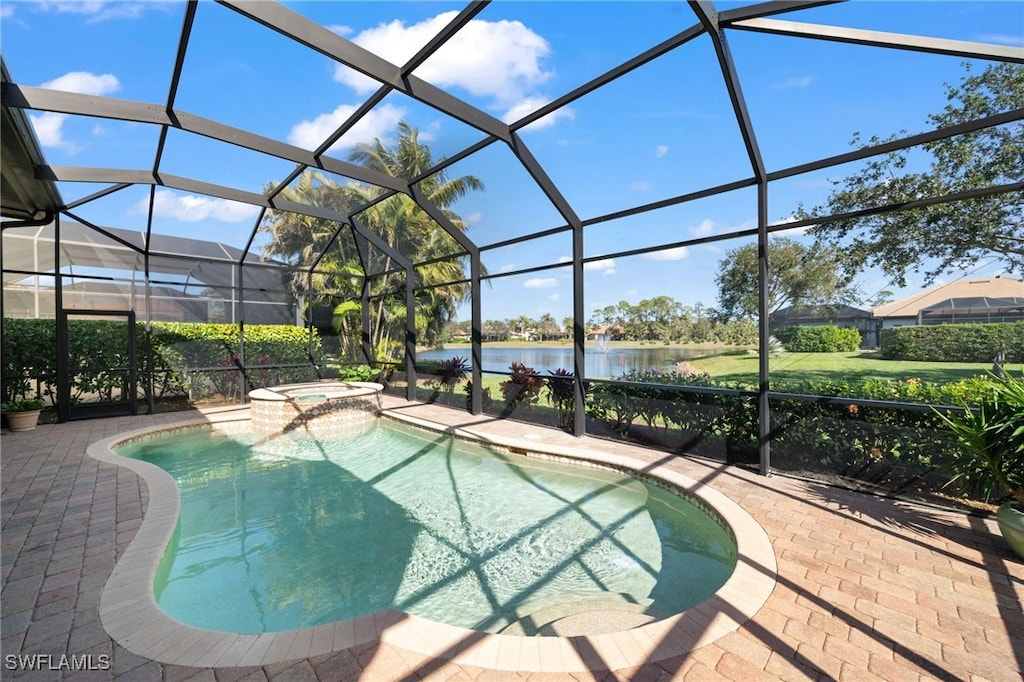 view of swimming pool featuring a water view, an in ground hot tub, a patio area, and a lanai