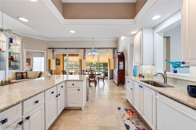 kitchen featuring tasteful backsplash, dishwasher, sink, and white cabinets