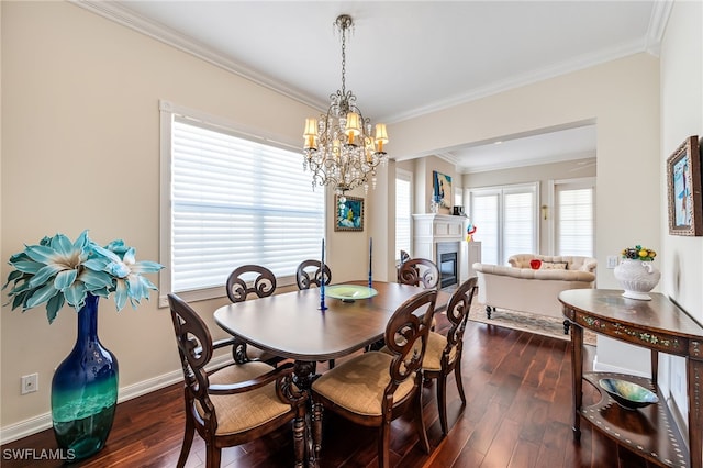 dining area with a notable chandelier, dark hardwood / wood-style floors, and crown molding