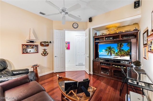 living room featuring ceiling fan and dark hardwood / wood-style flooring