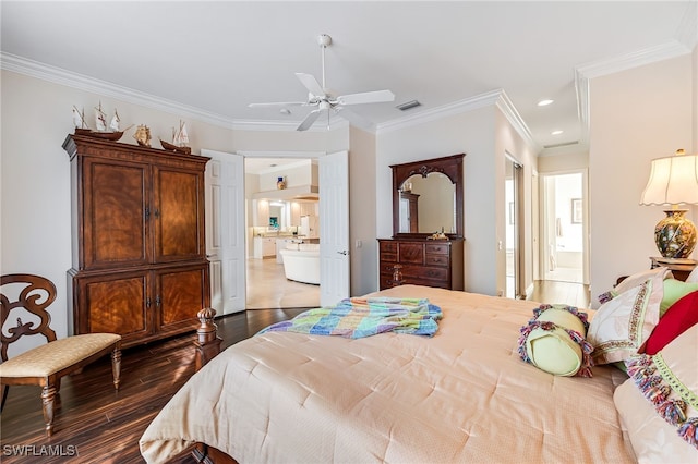 bedroom with hardwood / wood-style flooring, ceiling fan, ornamental molding, and ensuite bath