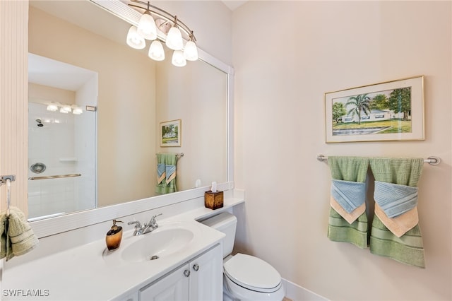 bathroom with vanity, toilet, and a shower with door