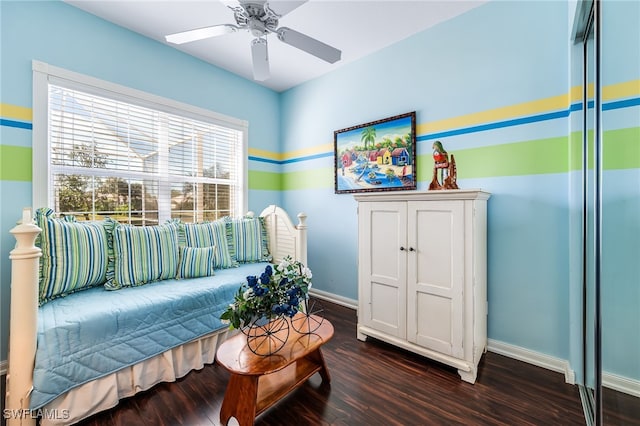 bedroom with dark hardwood / wood-style flooring and ceiling fan