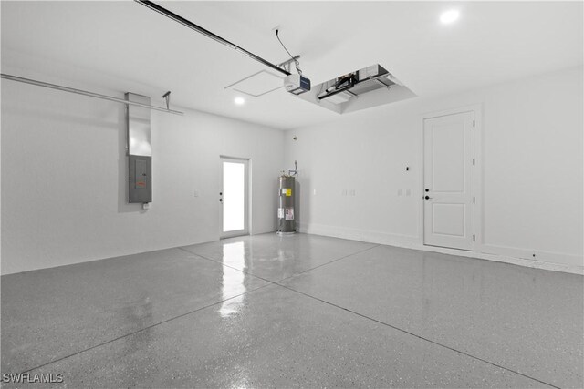 garage featuring electric panel, water heater, and a garage door opener