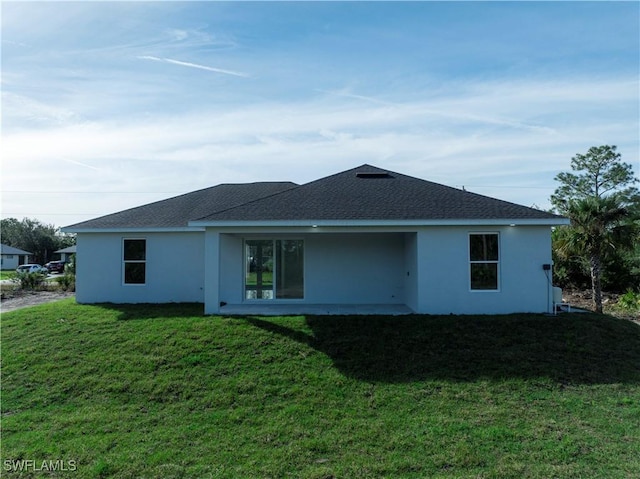 back of house featuring a yard