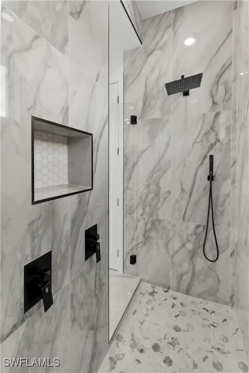 bathroom with a tile shower