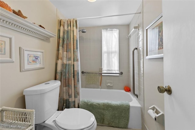 bathroom with shower / bath combination with curtain and toilet