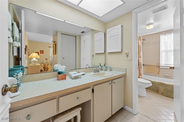 full bathroom with shower / bath combo, a skylight, vanity, tile patterned flooring, and toilet