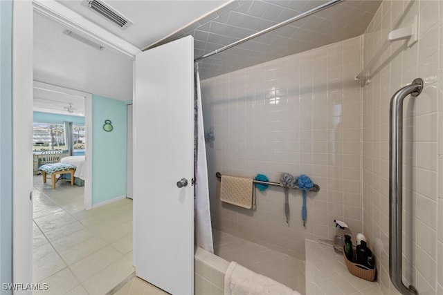 bathroom featuring a tile shower and tile patterned floors