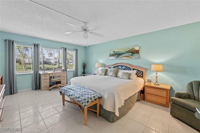 tiled bedroom featuring ceiling fan and a textured ceiling