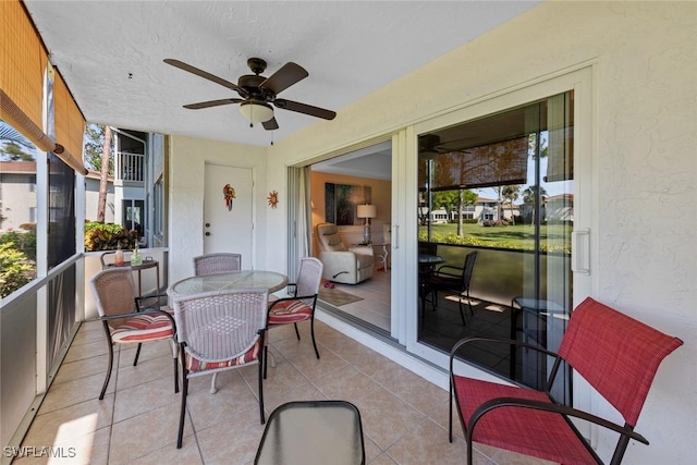 sunroom featuring ceiling fan