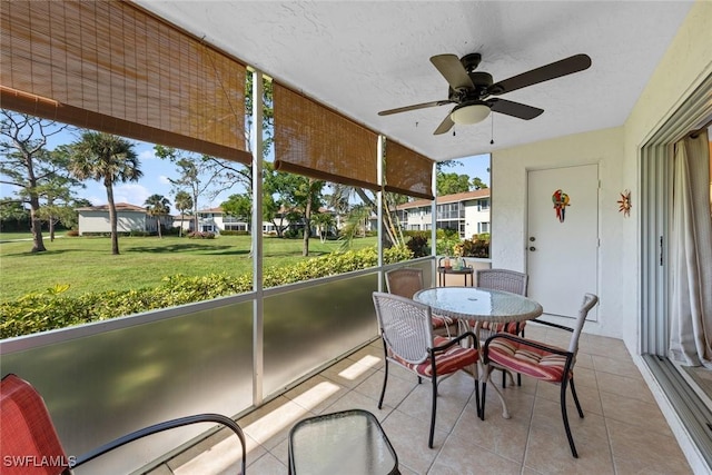 sunroom / solarium featuring ceiling fan