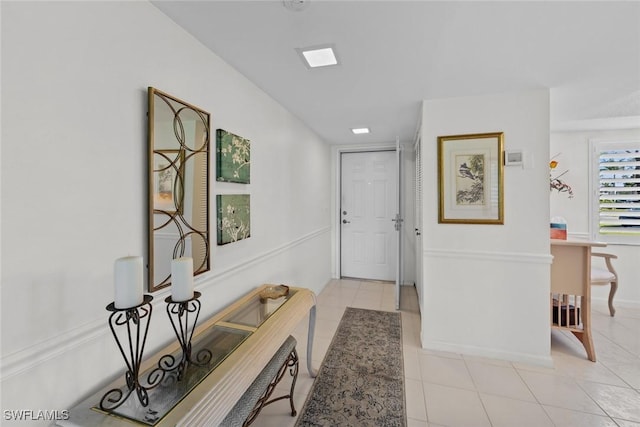 hall with light tile patterned floors