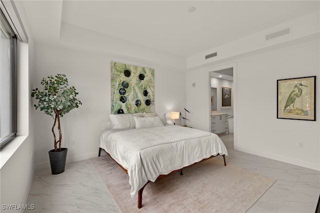 1125 Central Ave Unit 269, Naples, FL 34102 - bedroom with light marble finish flooring, baseboards, and ensuite bathroom