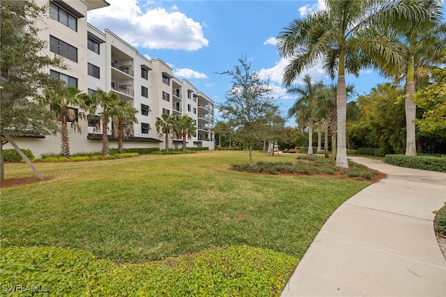 view of property's community with a yard