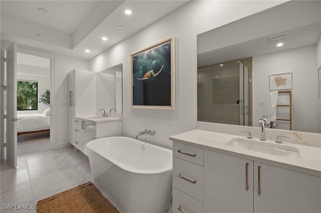 bathroom featuring vanity and shower with separate bathtub