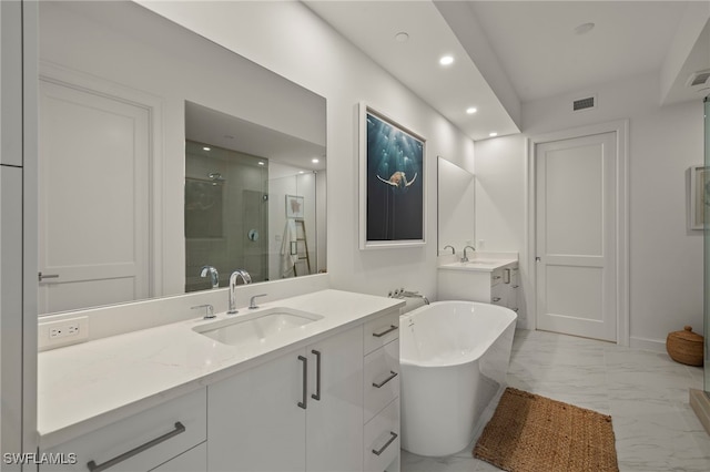 1125 Central Ave Unit 269, Naples, FL 34102 - full bathroom featuring a stall shower, recessed lighting, marble finish flooring, a freestanding bath, and two vanities