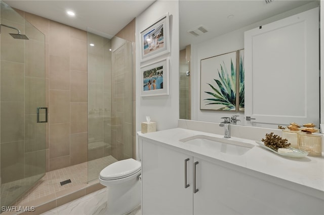 bathroom featuring vanity, an enclosed shower, and toilet