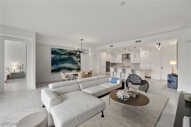 living room featuring an inviting chandelier and sink