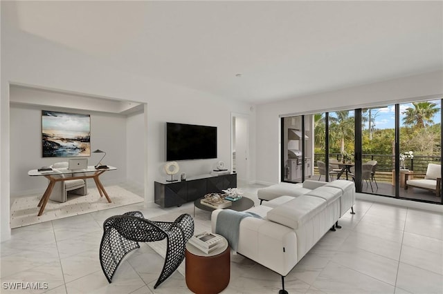 1125 Central Ave Unit 269, Naples, FL 34102 - living room featuring light marble finish flooring and baseboards