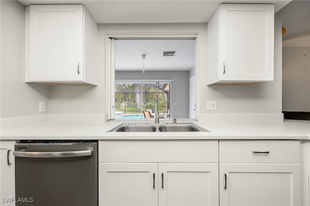 kitchen with stainless steel dishwasher, white cabinetry, and sink