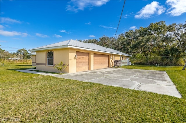 view of side of property with a yard and a garage