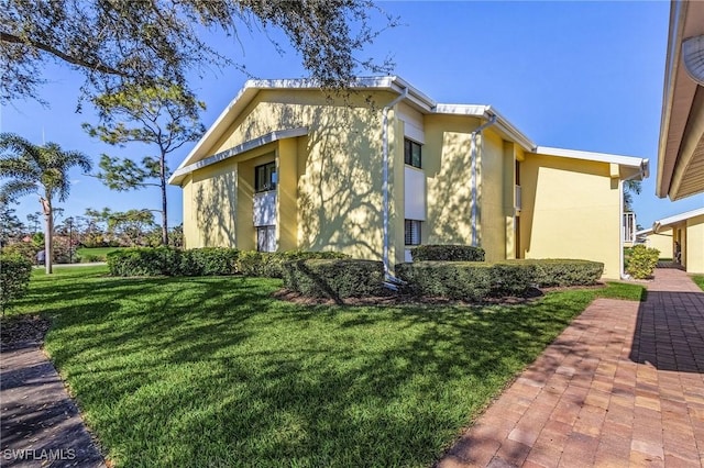 view of side of property with a lawn