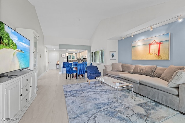 living room featuring track lighting and lofted ceiling