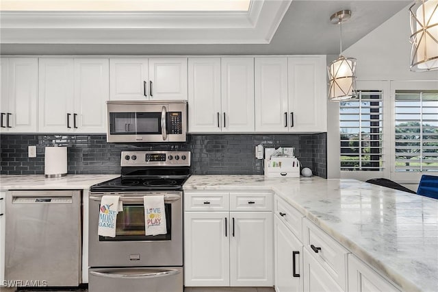 kitchen featuring decorative light fixtures, stainless steel appliances, and white cabinetry