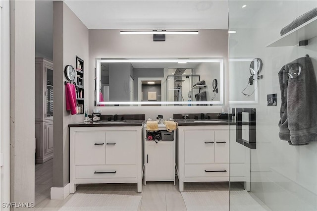 bathroom with tile patterned floors and vanity