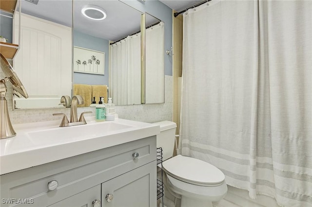 bathroom with vanity, toilet, and curtained shower