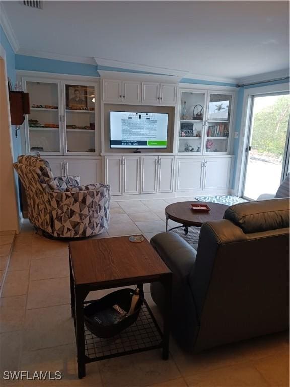 living room with light tile patterned flooring and ornamental molding